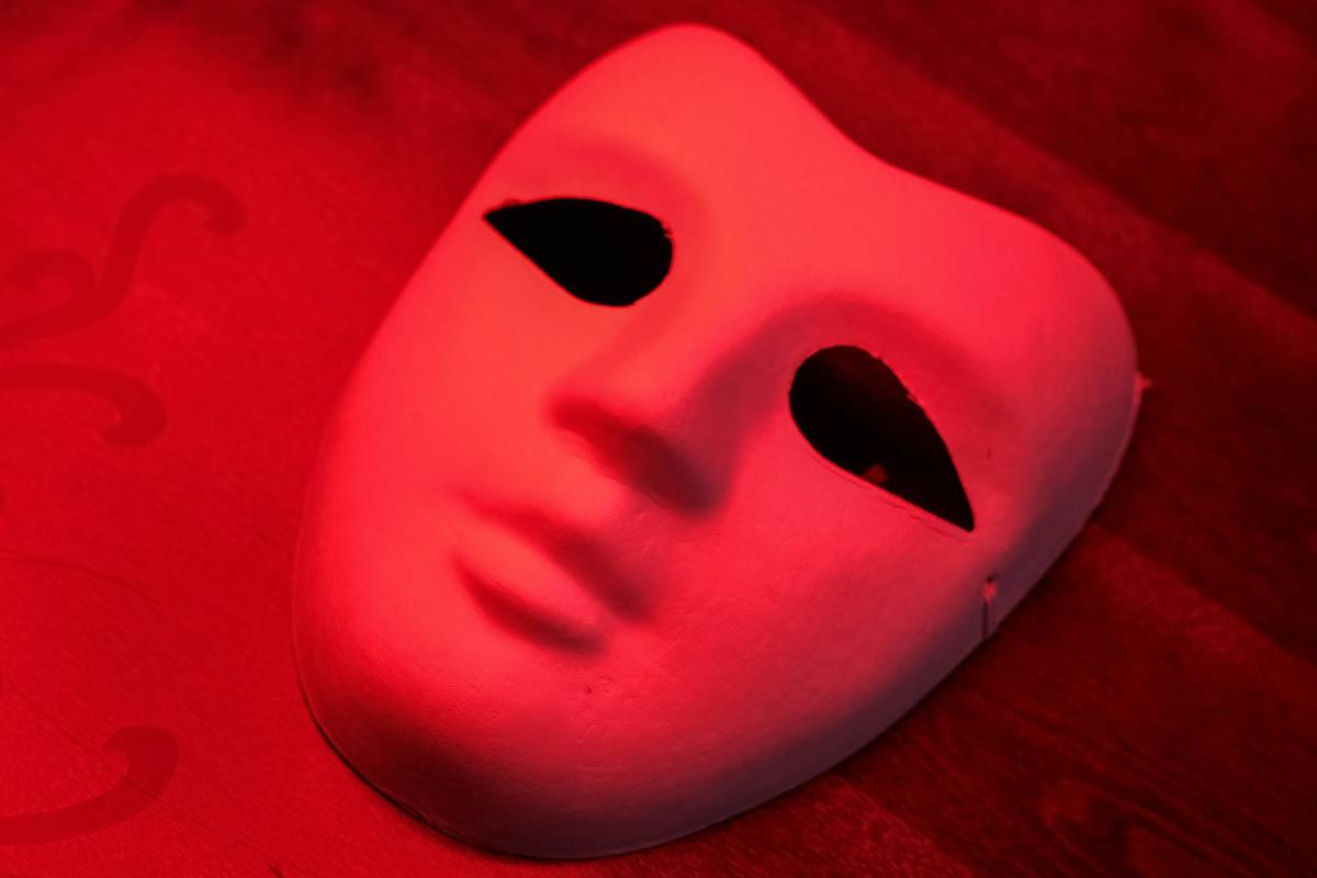 Woman using anti aging skin device with red light therapy on her face