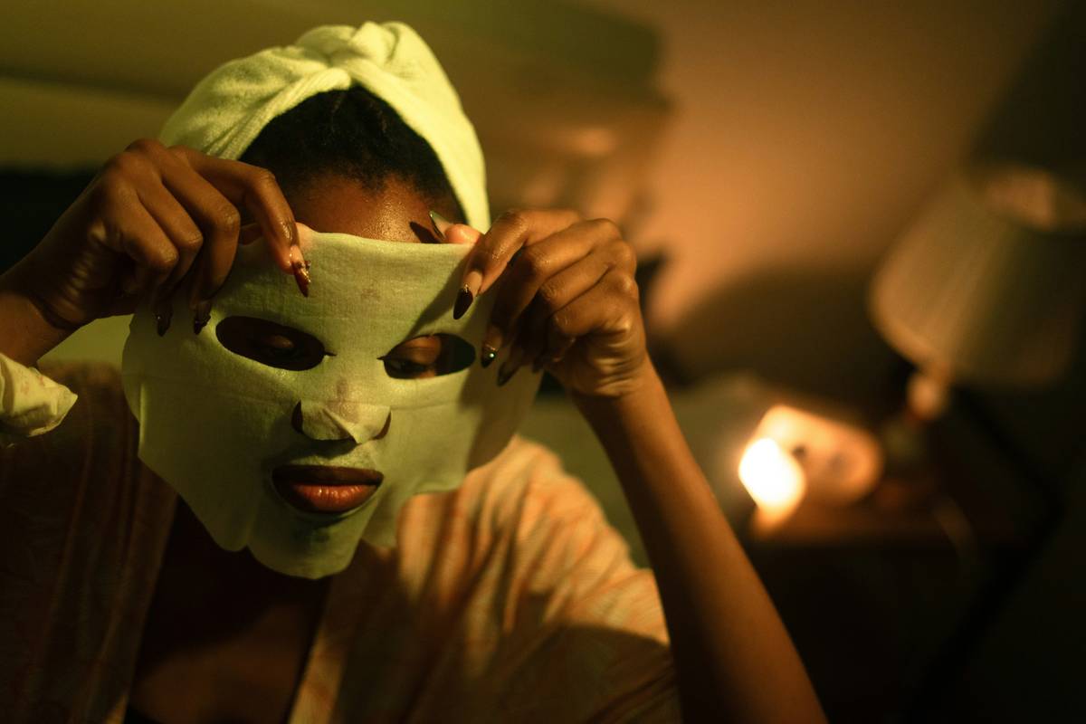 Woman using a handheld anti-aging facial device at home; facial treatments to reduce wrinkles in action